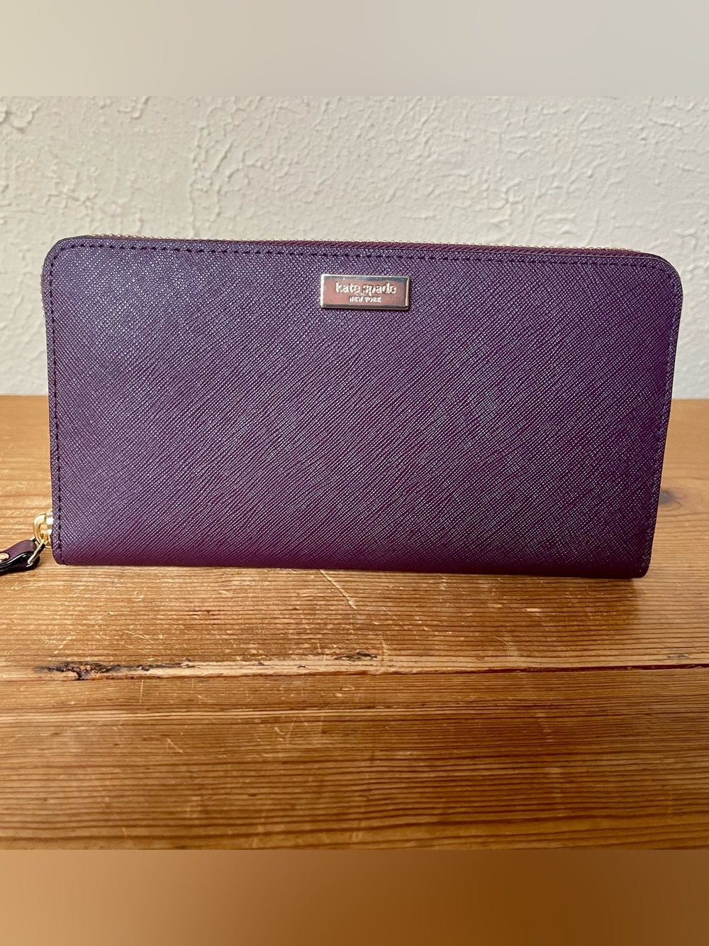 Kate Spade Saffiano leather zip-around continental wallet in a deep plum shade